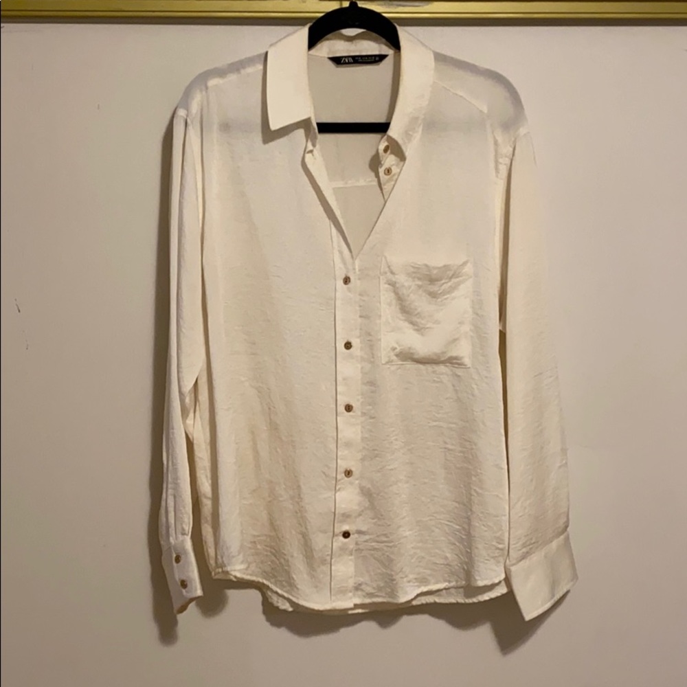 Cream colored button down shirt with pocket